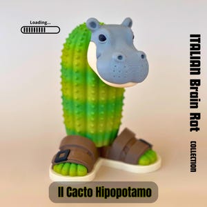 May include: A quirky sculpture of a hippo-cactus hybrid wearing sandals. The hippo head is light blue, the cactus body is green, and the sandals are brown. The text "Italian Brain Rot Collection" and "Il Cacto Hipopotamo" are also visible.
