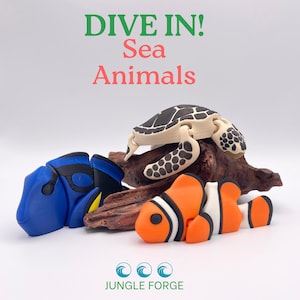 Puede incluir: Una colección de figuras de animales marinos impresas en 3D, que incluyen un pez cirujano azul, un pez payaso y una tortuga marina, con el texto "DIVE IN! Sea Animals". Las figuras de colores están sobre un trozo de madera flotante.