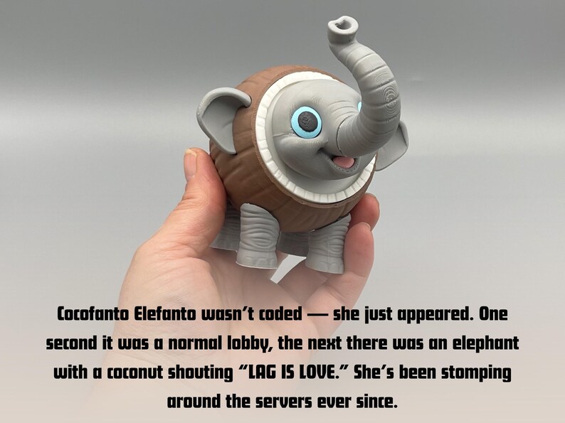 K&ouml;nnte beinhalten: Eine graue Elefantenfigur mit einem braunen, kokosnussartig texturierten K&ouml;rper, gro&szlig;en Ohren und blauen Augen. Der Text lautet: Cocofanto Elefanto wasn't coded &mdash; she just appeared. One second it was a normal lobby, the next there was an elephant with a coconut shouting &ldquo;LAG IS LOVE.&rdquo; She's been stomping around the servers ever since.