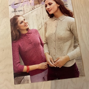May include: Vintage magazine cover featuring two women modeling knitwear. One woman wears a pink collared sweater, the other a beige cardigan. The magazine title is partially visible, with the words "celtic spun".
