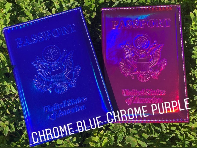 May include: Two passport holders, one blue and one purple, with a holographic finish. Both holders feature the text "PASSPORT" and the seal of the United States of America. The blue holder has the text "CHROME BLUE" and the purple holder has the text "CHROME PURPLE".