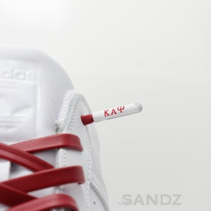 Kappa Alpha Psi leather shoelaces. White metal aglet with embossed Kappa Alpha Psi greek letters.