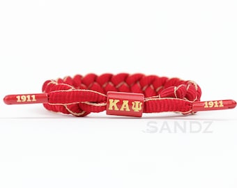 Kappa Alpha Psi Fraternity paracord bracelet with KAΨ centerpiece with the founding year 1911 embossed end caps. Perfect Gift!