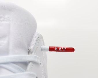 Kappa Alpha Psi shoelaces. Polyester with metal aglet with embossed Kappa Alpha Psi greek letters. 2 0ptions: White laces / Red Laces