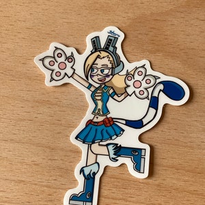 Puede incluir: Una pegatina con un personaje de dibujos animados con cabello rubio, que lleva un disfraz de gato azul y blanco con orejas de gato, una falda azul y botas azules. El personaje está sosteniendo dos patas blancas con almohadillas rosadas. La pegatina tiene la palabra "Johany" escrita en azul en la parte superior.