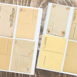 May include: Eight blank vintage postcards with different colors and designs. Some have lines for writing, others have a space for a stamp. All are in good condition.