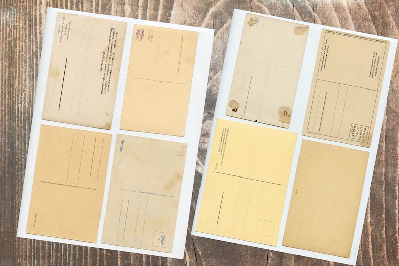 May include: Eight blank vintage postcards with different colors and designs. Some have lines for writing, others have a space for a stamp. All are in good condition.
