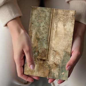 May include: A rectangular, vintage-style decorative panel with a distressed, aged appearance. The panel features a faded green and brown color scheme with ornate floral patterns and script-like text. The panel is held by a person.