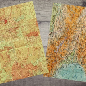 Peut inclure: Deux cartes anciennes, l'une avec un fond jauni et des lignes rouges, l'autre avec un fond brun et des lignes bleues. Les deux cartes montrent des d&eacute;tails g&eacute;ographiques.