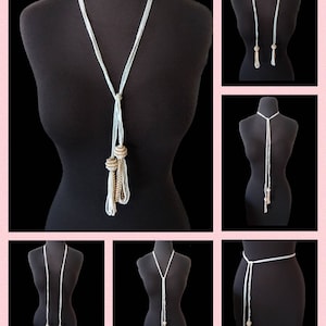 May include: A long, light blue beaded necklace with gold-toned beads and tassels. The necklace can be worn as a choker, a long necklace, or a belt.