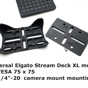 May include: Black plastic mount for a Stream Deck XL. The mount has a VESA 75 x 75 pattern and a 1/4-20 camera mount.