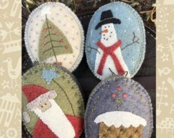 May include: Four felt ornaments with a winter theme. The ornaments are oval shaped and feature a snowman, a Christmas tree, Santa Claus, and a gingerbread house. The ornaments are decorated with embroidery and are labeled "Snowmen & Santa Decorations".