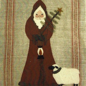 May include: A vintage-style illustration of Santa Claus in a red robe holding a small Christmas tree and a lantern. A white sheep stands beside him. The image has a rustic, homespun feel and includes the text "1800 St. Nick".