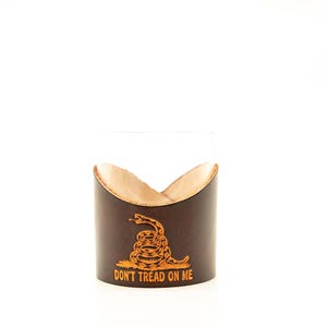 May include: A brown leather wrapped glass with a gold snake and the text "Don't Tread On Me".