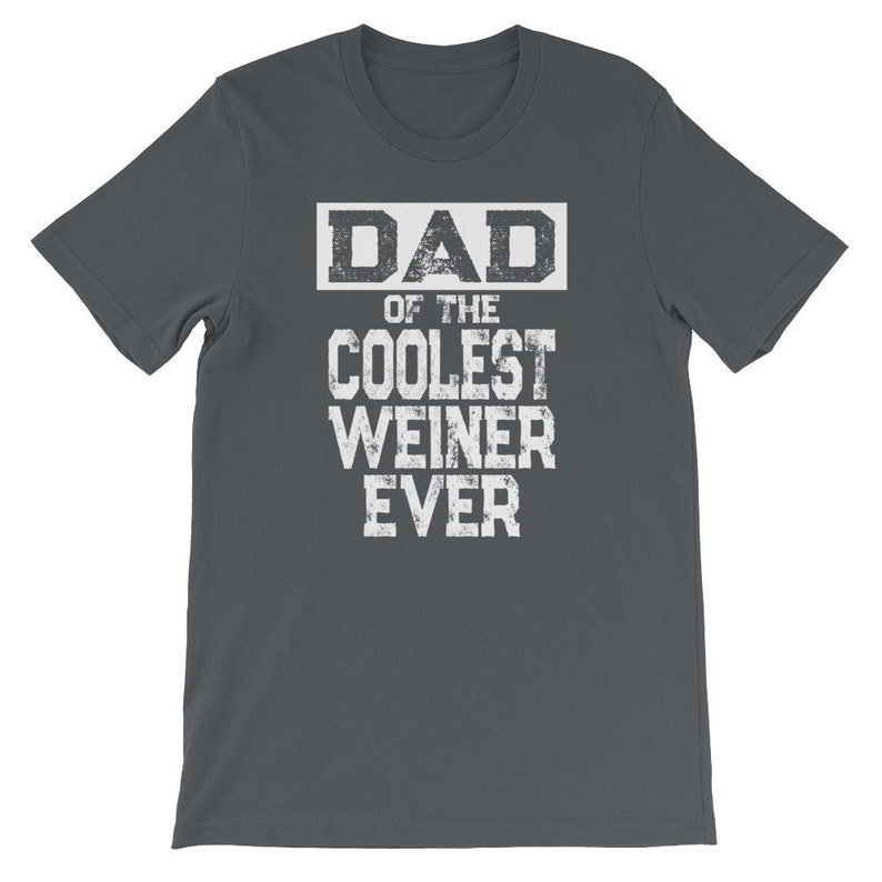 May include: Dark gray t-shirt with white text that reads "DAD OF THE COOLEST WEINER EVER".