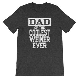 May include: Dark heather grey t-shirt with white text that reads "DAD of the COOLEST WEINER EVER".