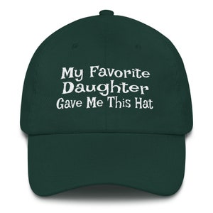 May include: A dark green baseball cap with white embroidered text that reads "My Favourite Daughter Gave Me This Hat".