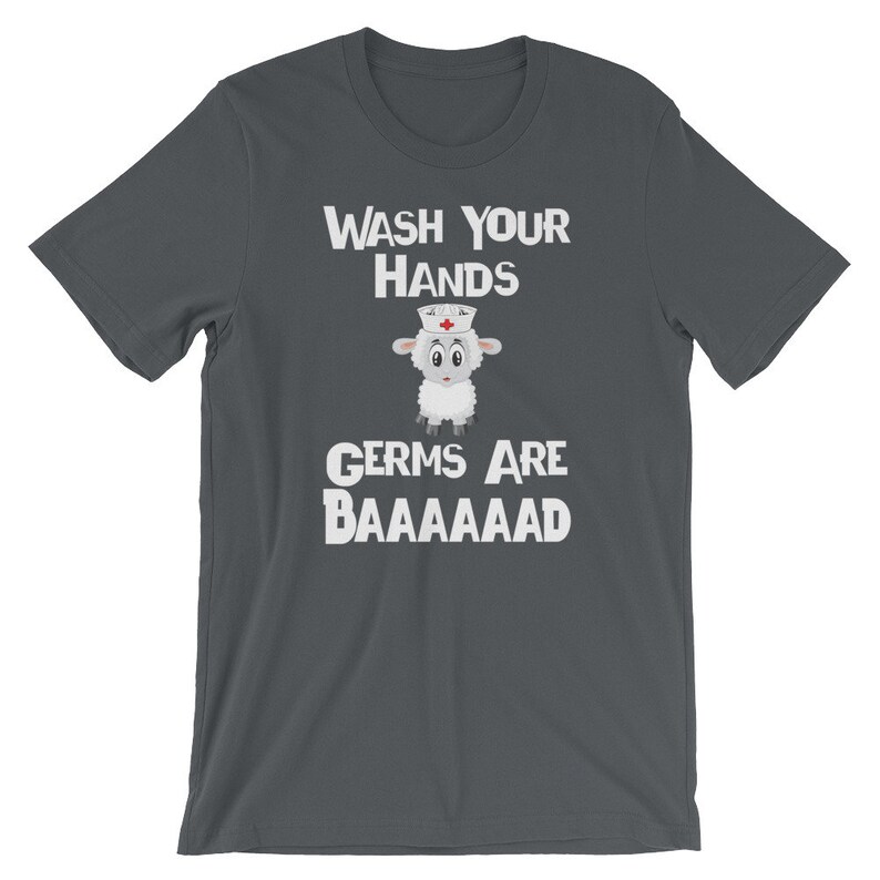 May include: Dark grey t-shirt with a white graphic of a sheep wearing a nurse's hat. The text "WASH YOUR HANDS GERMS ARE BAAAAAAAAD" is printed on the shirt.