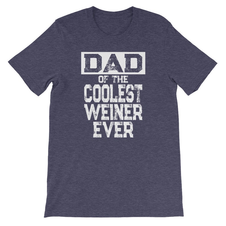May include: A heather blue t-shirt with a white graphic that reads "DAD OF THE COOLEST WEINER EVER".