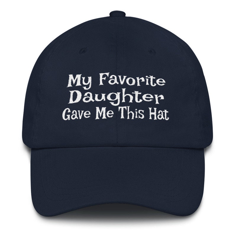 May include: A navy blue baseball cap with white embroidered text that reads "My Favourite Daughter Gave Me This Hat".