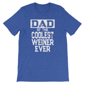 May include: A blue t-shirt with white text that reads "DAD of the COOLEST WEINER EVER".