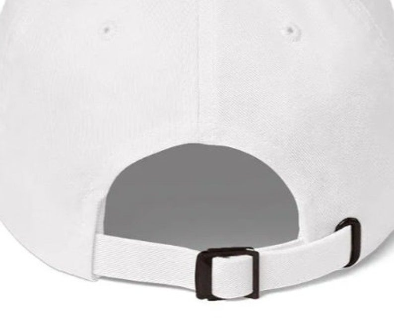 May include: White baseball cap with an adjustable strap and buckle closure. The back of the cap is blank.