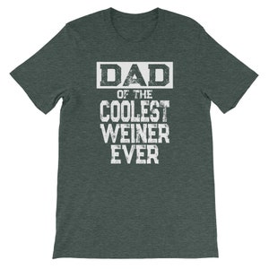 May include: Dark green t-shirt with white text that reads "DAD of the COOLEST WEINER EVER".