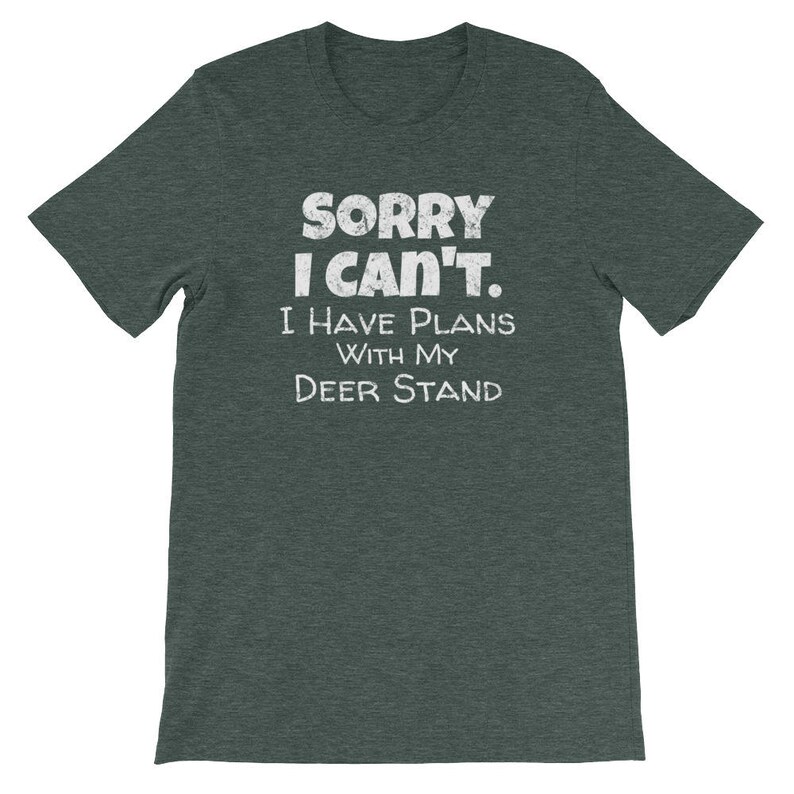 May include: A dark green t-shirt with the text "Sorry I can't. I have plans with my deer stand" in white.