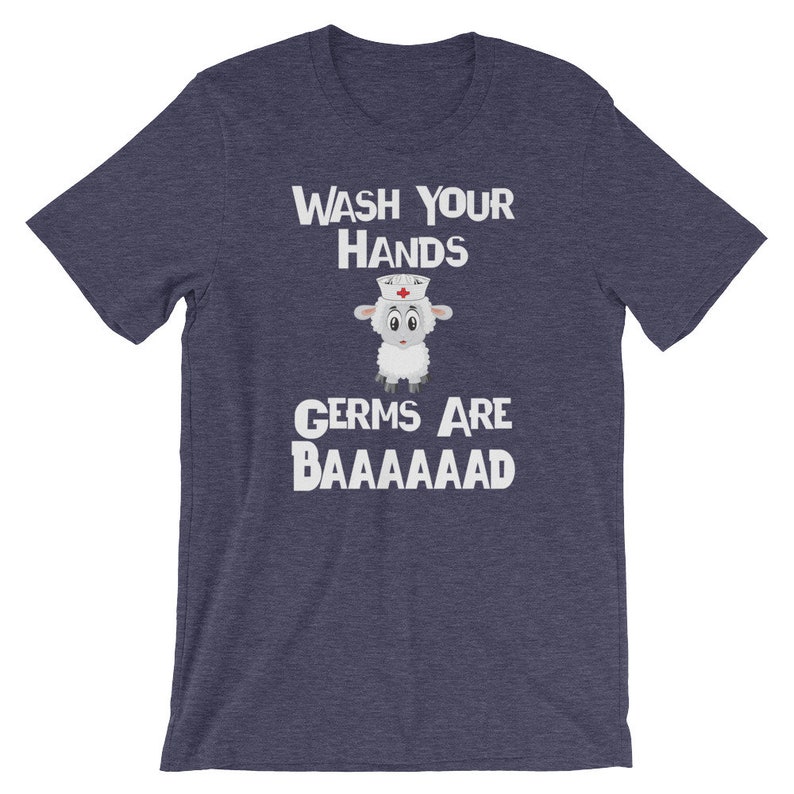 May include: A navy blue t-shirt with a white graphic of a sheep wearing a nurse's hat. The text "WASH YOUR HANDS GERMS ARE BAAAAAAAAD" is printed on the shirt.