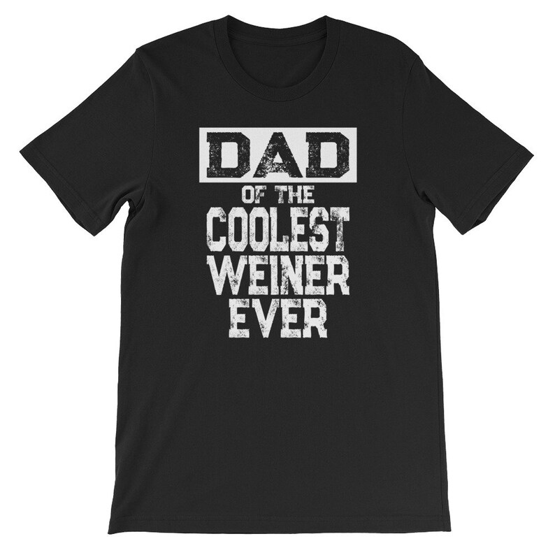 May include: Black t-shirt with white text that reads "DAD OF THE COOLEST WEINER EVER".