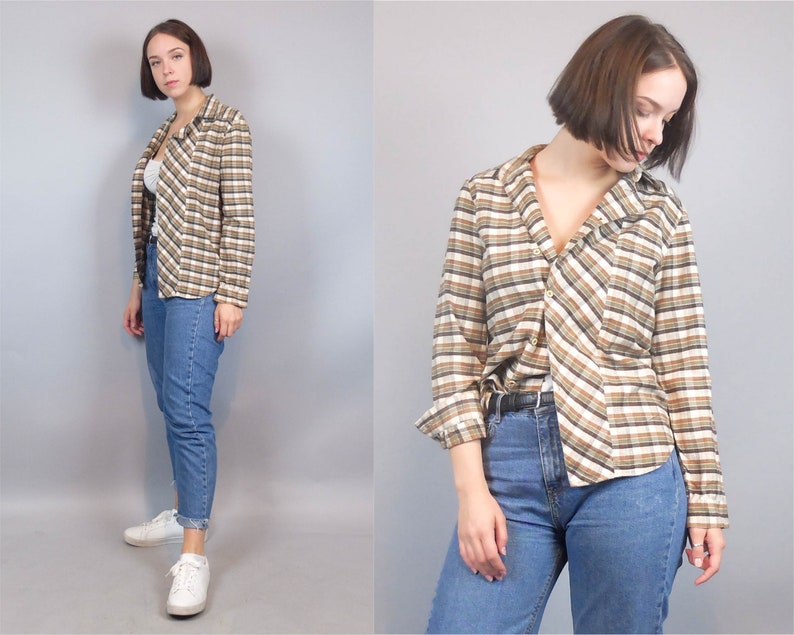 May include: A long-sleeved, button-down shirt with a brown and white plaid pattern. The shirt has a relaxed fit and a slightly oversized collar.