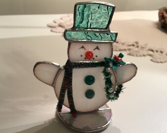 Snowman standing on base, handcrafted stained glass table decoration.