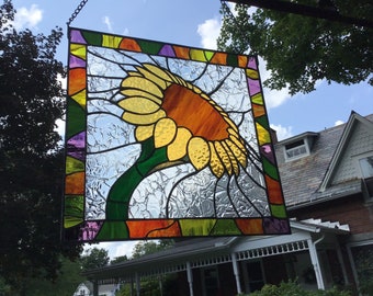 Sunflower stained glass panel with colorful border.