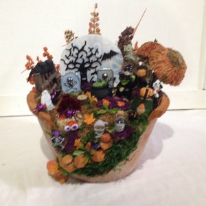 Halloween handcrafted scene in a terra cotta pot.