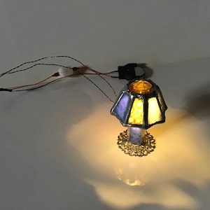 Dollhouse 8 panel stained glass lamp with battery operated lights.