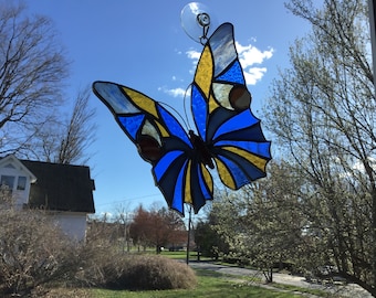 Butterfly in blues and gold, handcrafted stained glass suncatcher.