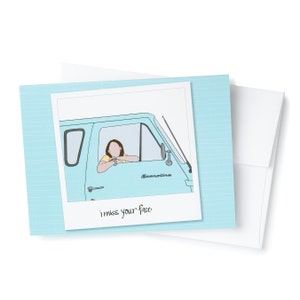 May include: A blue and white Polaroid photo with a drawing of a person driving a blue van with the word "Econoline" on the side. The text "i miss your face" is written below the photo.