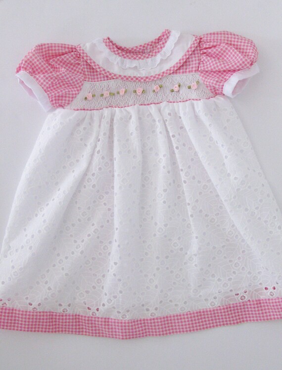 Pretty in pink and white. UNIQUE Toddler smocked dress. Handmade with cotton and eyelet embroidery fabric. Pretty in pink and white. UNIQUE Toddler smocked dress. Handmade with cotton and eyelet embroidery fabric.
