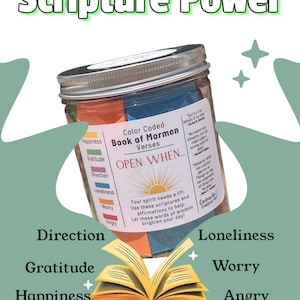 May include: A glass jar with a silver lid filled with colorful paper strips. The jar is labeled "Color Coded Book of Mormon Verses" and has the words "Open When..." written on it. The jar is sitting on top of an open book with the words "Direction", "Gratitude", "Happiness", "Loneliness", "Worry", and "Angry" written on the pages.