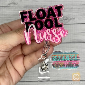 May include: Pink glitter badge holder with a black and white text overlay that reads "FLOAT POOL NURSE". The badge holder is attached to a clear retractable badge reel.