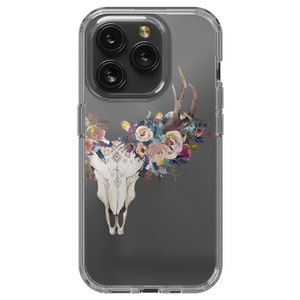 May include: A clear phone case with a floral design. The design features a white skull with antlers and a floral wreath around the skull. The flowers are in shades of pink, blue, and purple.