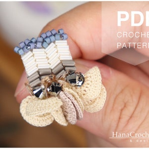 May include: A crochet earring pattern PDF featuring a beaded and crocheted flower design. The pattern is available for download and includes instructions for creating the earring.