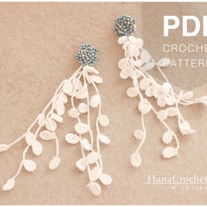 May include: A pair of white crochet earrings with a blue beaded top. The earrings are shaped like a cascade of leaves. The image includes the text "PDF CROCHET PATTERN".