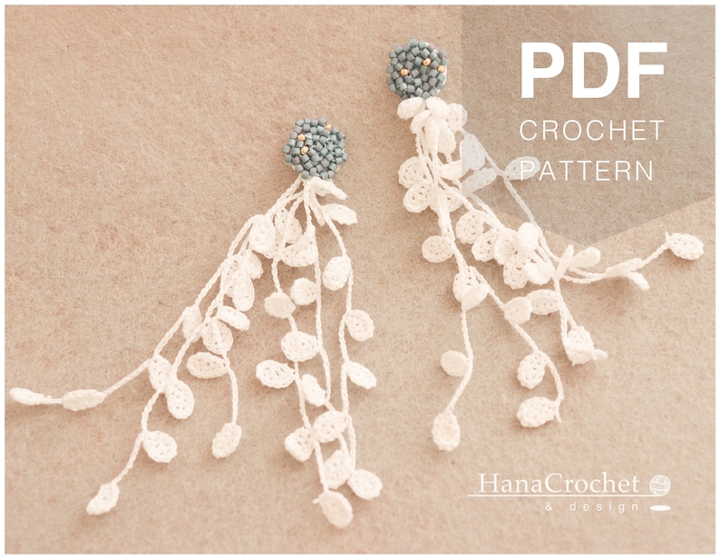 May include: A pair of white crochet earrings with a blue beaded top. The earrings are shaped like a cascade of leaves. The image includes the text "PDF CROCHET PATTERN".