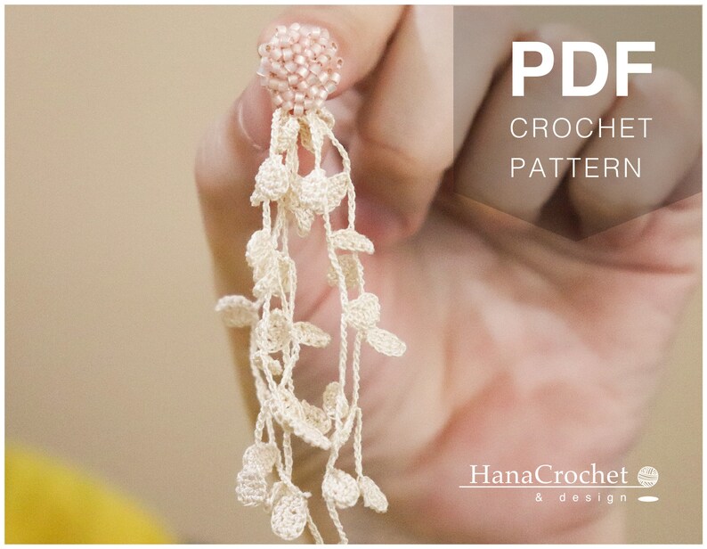 May include: A PDF crochet pattern for a delicate white crocheted earring with a pink beaded top. The pattern is by Hana Crochet & design.