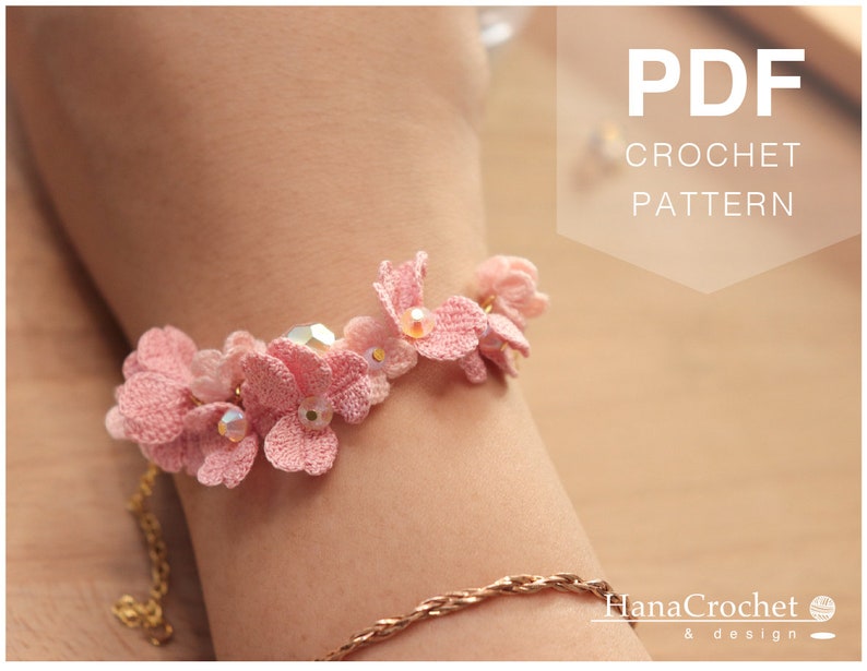 May include: A pink crocheted flower bracelet with clear beads. The bracelet is on a person's wrist. The image also includes the text "PDF CROCHET PATTERN".