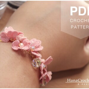 May include: A pink crochet bracelet with delicate flower accents and crystal beads. The bracelet is on a person's wrist. The image includes the text "PDF CROCHET PATTERN".