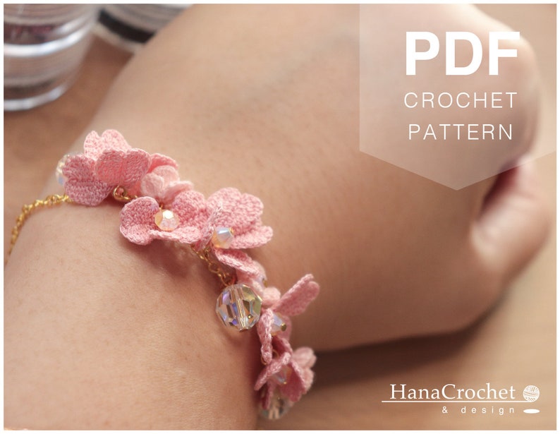 May include: A pink crochet bracelet with delicate flower accents and crystal beads. The bracelet is on a person's wrist. The image includes the text "PDF CROCHET PATTERN".