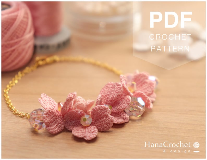 May include: A PDF crochet pattern for a delicate pink flower necklace with crystal beads. The pattern is available for download and includes instructions for creating the necklace.