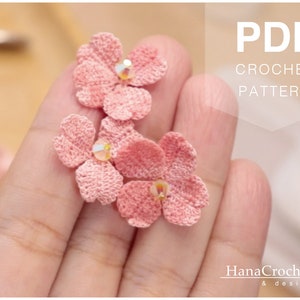 May include: A PDF crochet pattern for making delicate pink crocheted flowers. The pattern is available for download and includes instructions for creating the flowers.